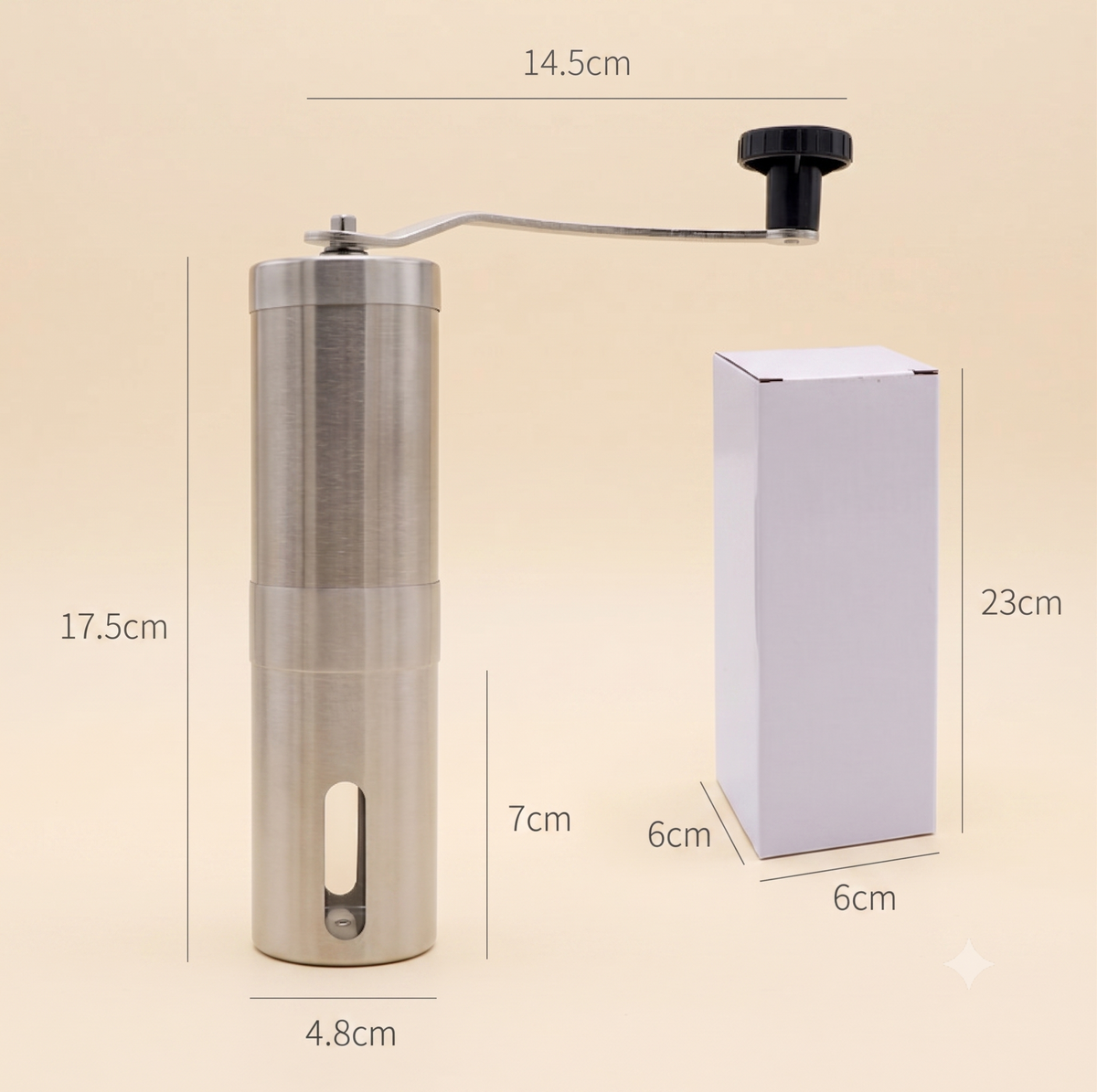 Manual coffee grinder with dimension labels next to its packaging box on a beige background.